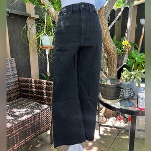 High-waisted black wide-leg jeans with frayed hem